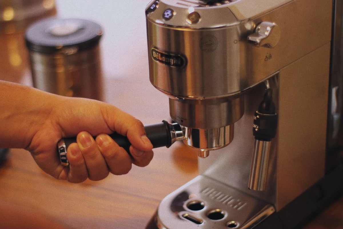 Portafilter loaded with freshly ground espresso coffee, ready for brewing
