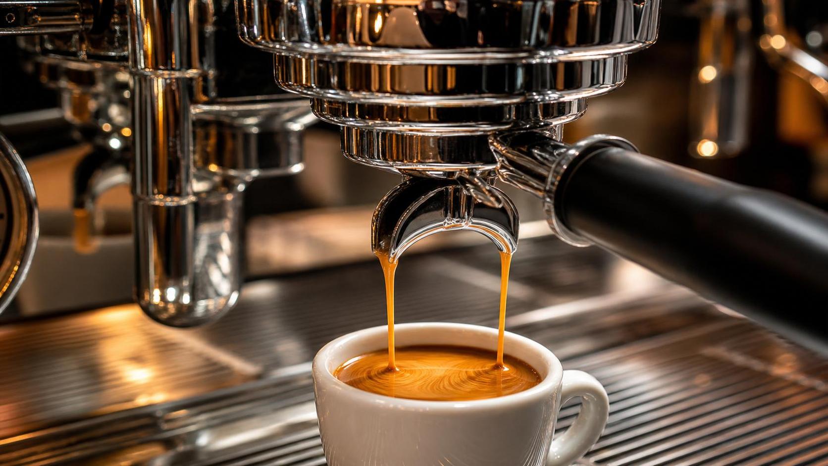 E61 group head during espresso extraction showing even flow from dual spouts