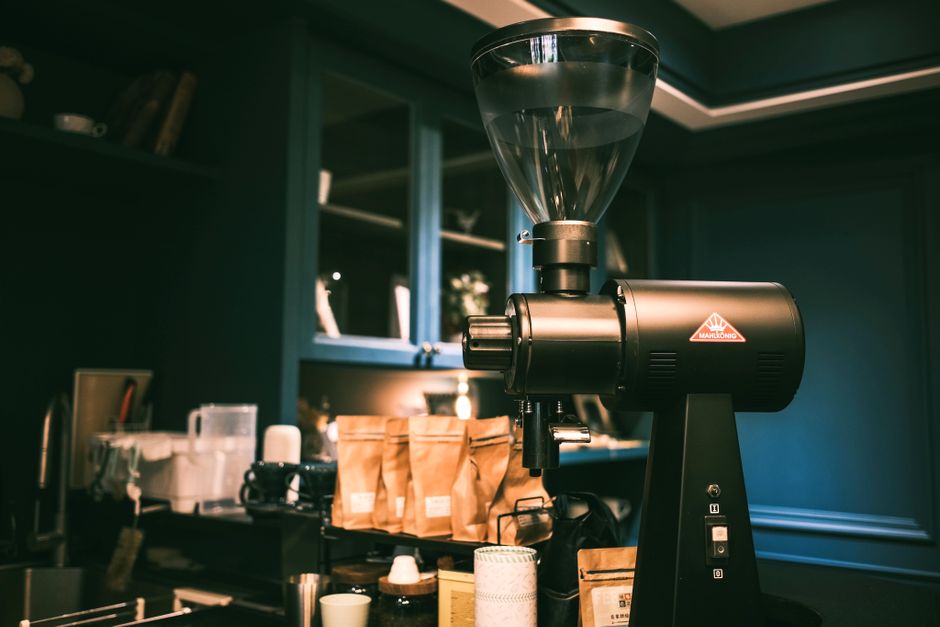 Two entry-level espresso grinders side by side on kitchen counter