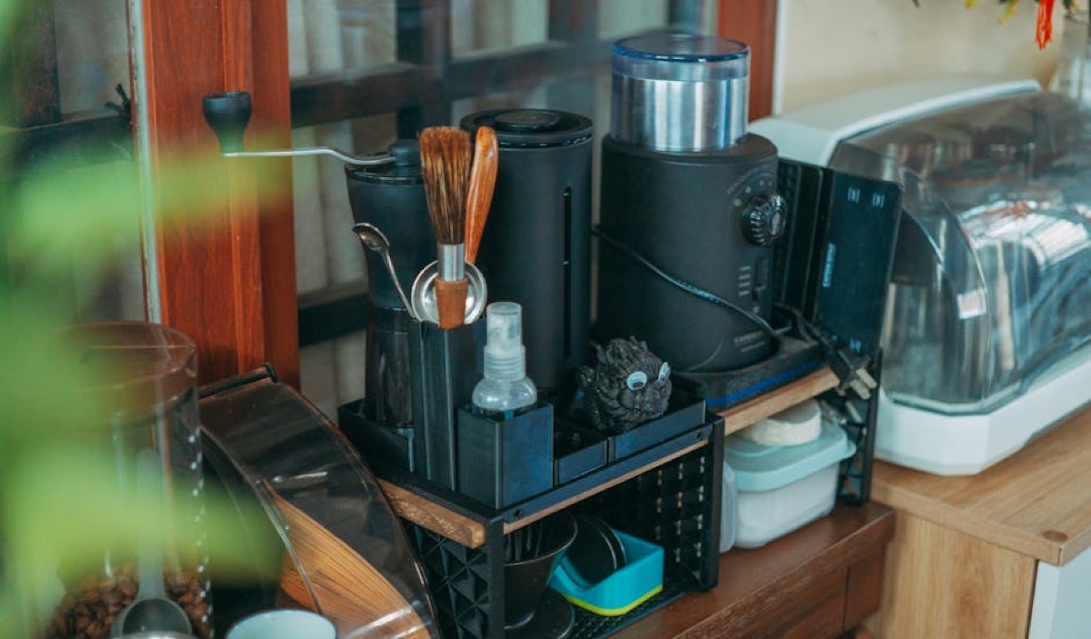 Coffee equipment setup showing grinder and maintenance tools on counter