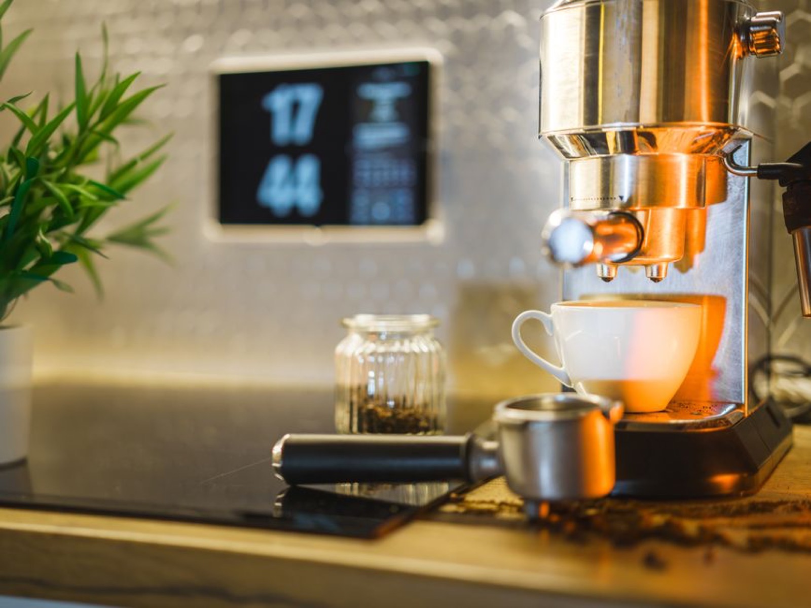 Home espresso machine setup with coffee beans and cup on kitchen counter