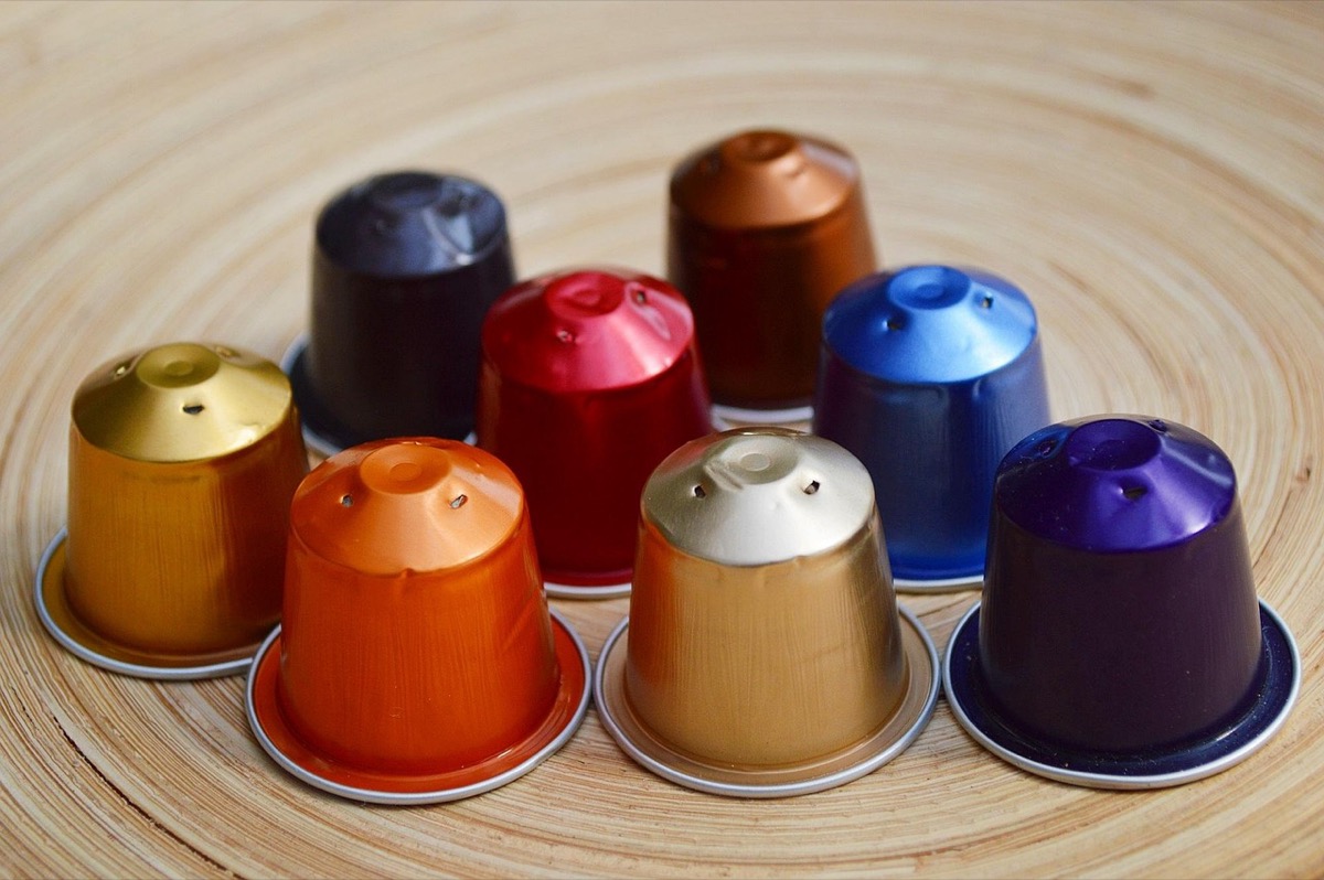 Nespresso-style coffee capsules arranged on a wooden surface