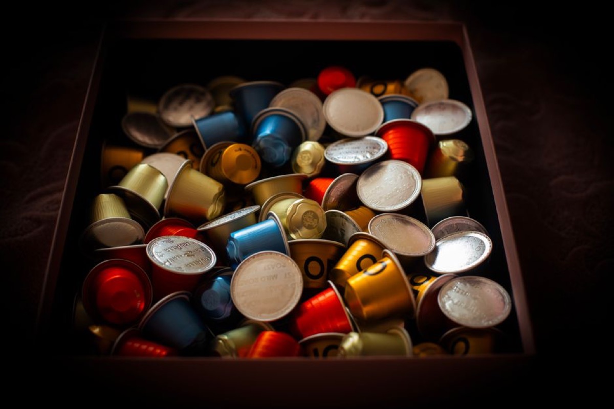 Two espresso shots being extracted into clear glasses showing rich crema