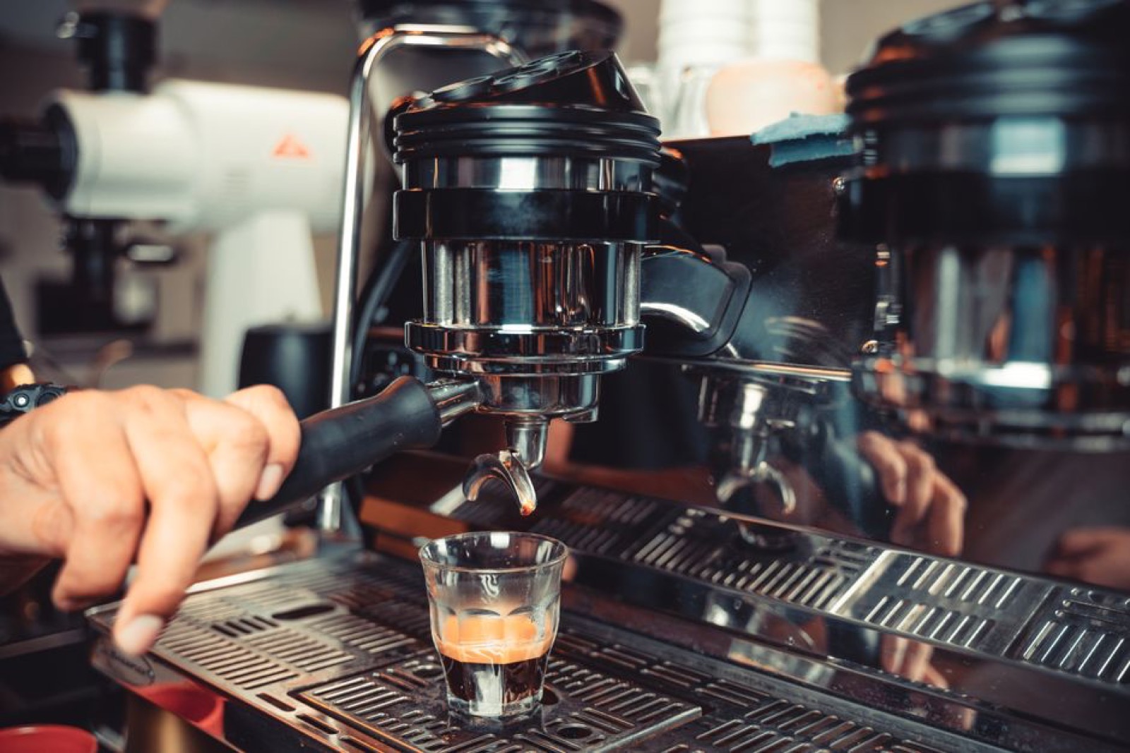 Barista pulling an espresso shot on a traditional machine