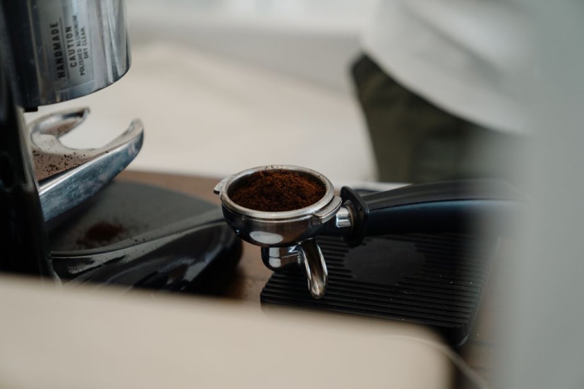 Portafilter loaded with fresh espresso grounds ready for extraction
