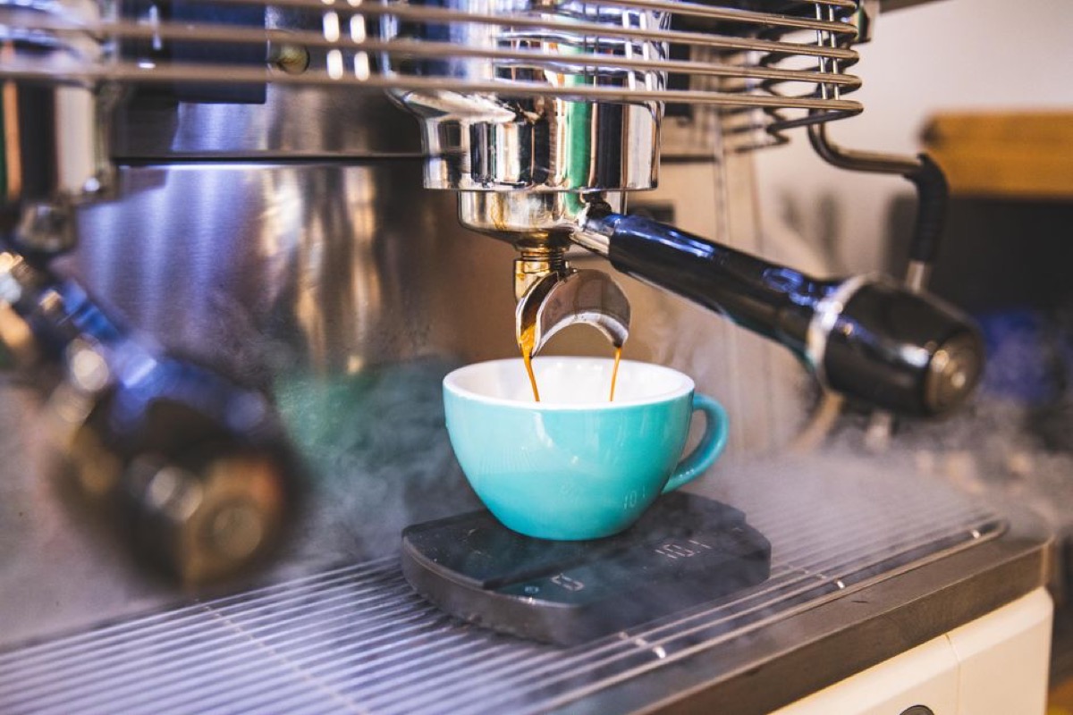Espresso extraction from professional machine showing daily use workflow