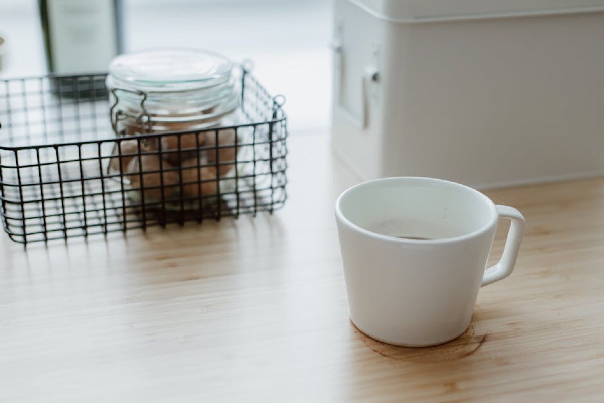 Clean home kitchen counter with coffee cup showing minimalist maintenance routine
