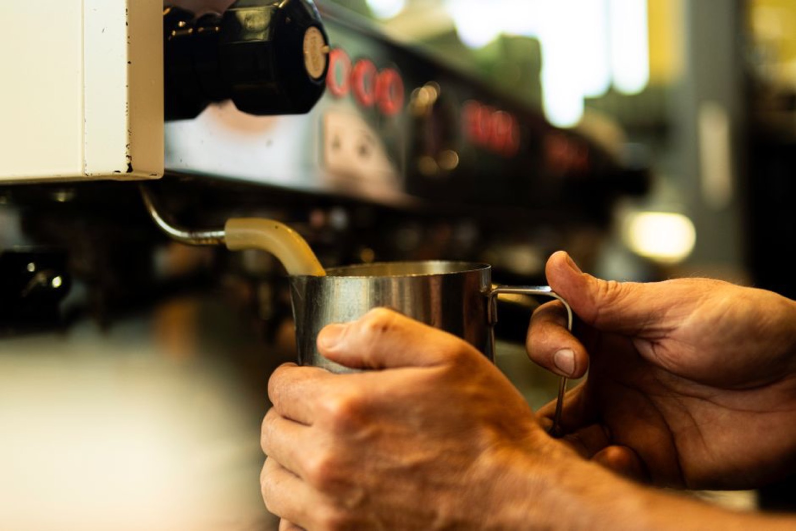 Home barista pulling espresso shot on prosumer machine